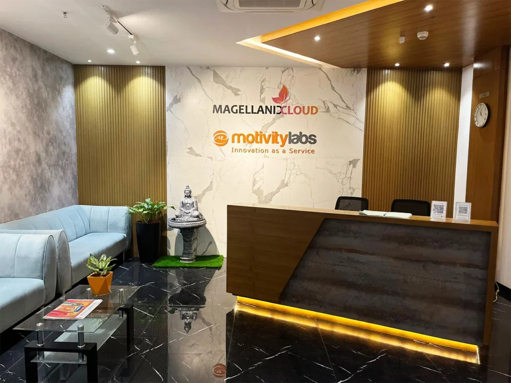 Reception area of a Motivity Labs office, with the Motivity Labs and Magellanic Cloud logos on the wall behind the front desk